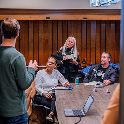 Group of people listening to someone presenting.