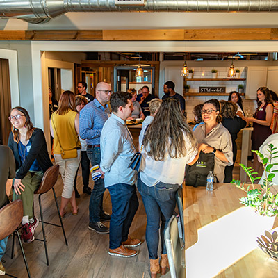 A group of people in a room networking.